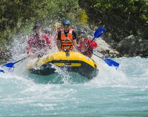 Group an a yellow raft doing white water rafting